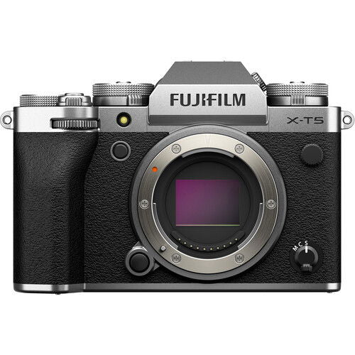 Mirrorless camera body with lens, textured grip, and top control panel