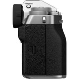 Mirrorless camera body close-up, textured handgrip and silver top controls