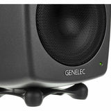 Close-up of dark gray active studio monitor woofer grille and status LED