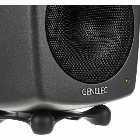 Close-up of dark gray active studio monitor woofer grille and status LED