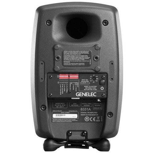Back of active studio monitor speaker showing label panel, controls, and mounting points