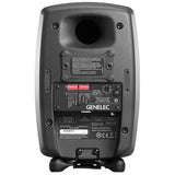 Back of active studio monitor speaker showing label panel, controls, and mounting points