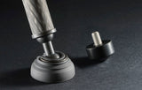 Tripod base close-up: rubber foot and leveling knob on carbon-fiber leg, black