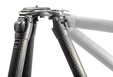 Tripod head with adjustment knobs and carbon-fiber legs, angled view, black