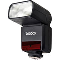 Black TTL camera flash with swiveling head and diffuser panel, front view