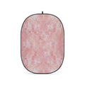 Pink textured oval foldable backdrop with black border and top hanging loop.