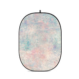 Portable oval collapsible backdrop with multicolor pastel abstract print and black edge