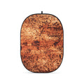 Rust-orange textured oval photo backdrop with black border and hanging loop
