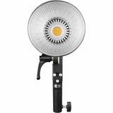 Front view of ML60 LED light with silver reflector panel and black handle stand