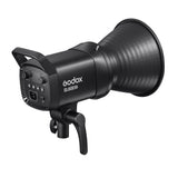 Angled LED studio light with back controls, black body, and vented grip