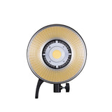 LED studio light front with warm yellow diffuser and circular reflector