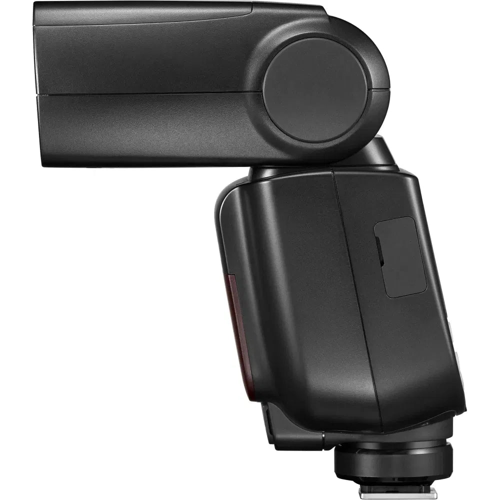 Black TTL camera flash body with side dial and control panel, angled close-up