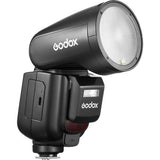 Compact TTL camera flash with round reflector head, black housing and side buttons