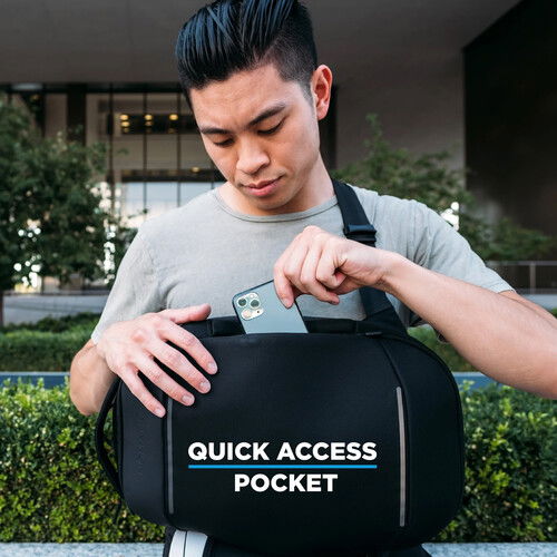 Black sling bag worn crossbody with quick-access pocket feature on front