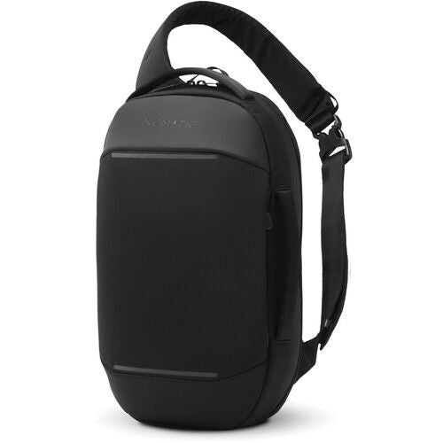 Black sling backpack bag with curved top handle and wide shoulder strap
