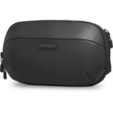 Black sling bag with textured shell, zippered front pocket and logo patch