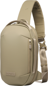 Sand beige sling bag side view with adjustable strap and zip pull tab