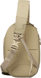 Sand beige sling bag showing adjustable buckle strap and side pass-through pocket