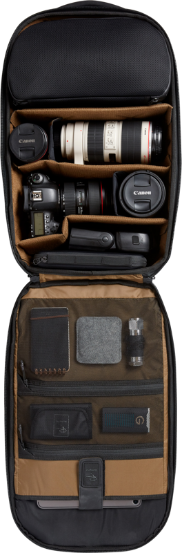 Open camera backpack with tan organizers, lens and camera bodies in padded slots