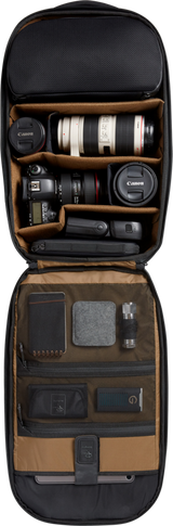Open camera backpack with tan organizers, lens and camera bodies in padded slots