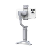 White smartphone gimbal stabilizer with fold-out tripod base and phone holder