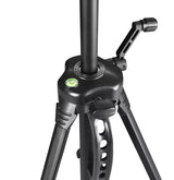 Close-up of black tripod head with bubble level and locking knobs