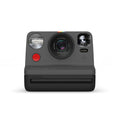 Black instant film camera with lens, flash, and i-Type film slot