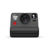 Black instant film camera with lens, flash, and i-Type film slot