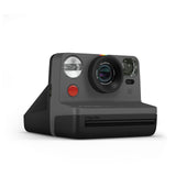 Black instant film camera front view with lens, flash, and i-Type film slot