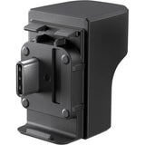 Back view of dark gray microphone adapter with mounting clips and port opening