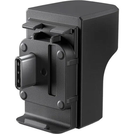 Back view of dark gray microphone adapter with mounting clips and port opening