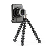Black flexible mini tripod with camera mounted; flexible legs splayed outward