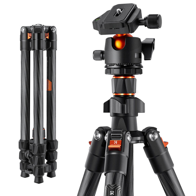Carbon-fiber photo tripod with black head, orange accents, and adjustable knobs