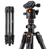 Black carbon-fiber tripod head close-up with locking dials and orange accents