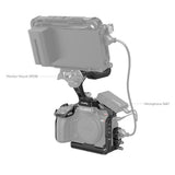 Black camera rig with monitor and microphone mounts for Lumix; cables attached