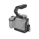Black camera cage rig with top handle and side mounting plate for Lumix mirrorless