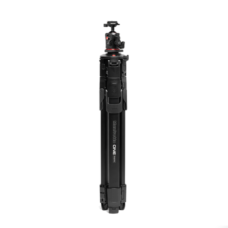 Vertical view of black tripod with ball head and center column; red accents on controls