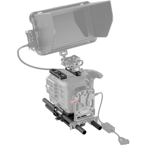 Camera accessory kit mounted on cage, with control rails and cable connection