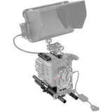 Camera accessory kit mounted on cage, with control rails and cable connection