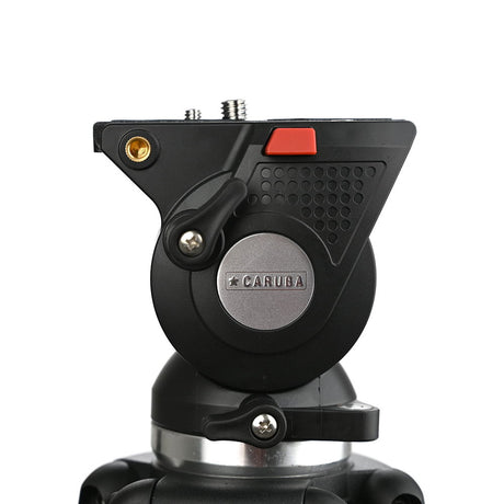 Tripod head base close-up with silver pivot ring and textured grip controls.