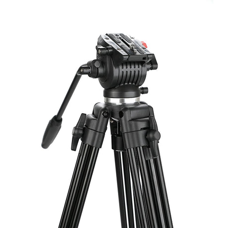 Black tripod head close-up with adjustment controls and mounted handle.