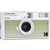 Half-frame film camera front view with green striped panel, lens, and flash window