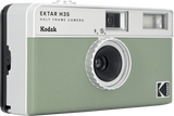 White and green half-frame camera showing circular front lens and flash window