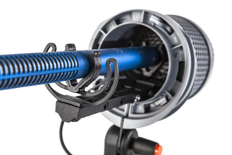 Open shock mount with blue tube and metal grille attachment, close-up