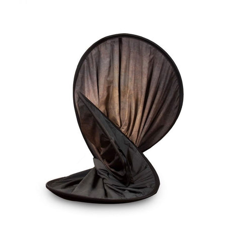 Folded portable photo backdrop in dark case, walnut interior visible