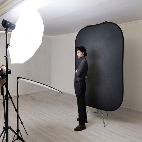 Pewter/charcoal portable photo backdrop panel on a stand in studio