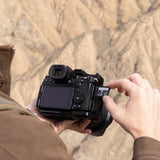 Camera held in hands with SD card inserted