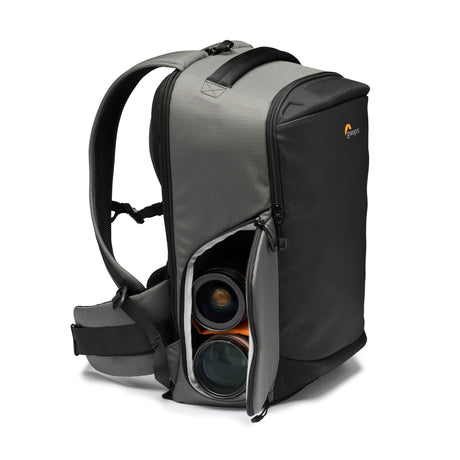 Gray camera backpack side view with open compartments holding two camera lenses