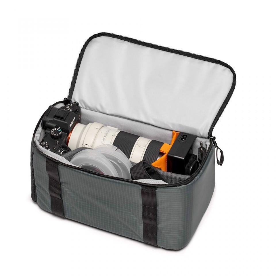 Open camera lens case with zip lid, dark gray sides, white interior and orange divider