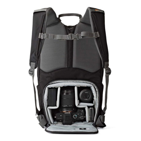 Open camera backpack with DSLR and lens stored in padded partitioned insert